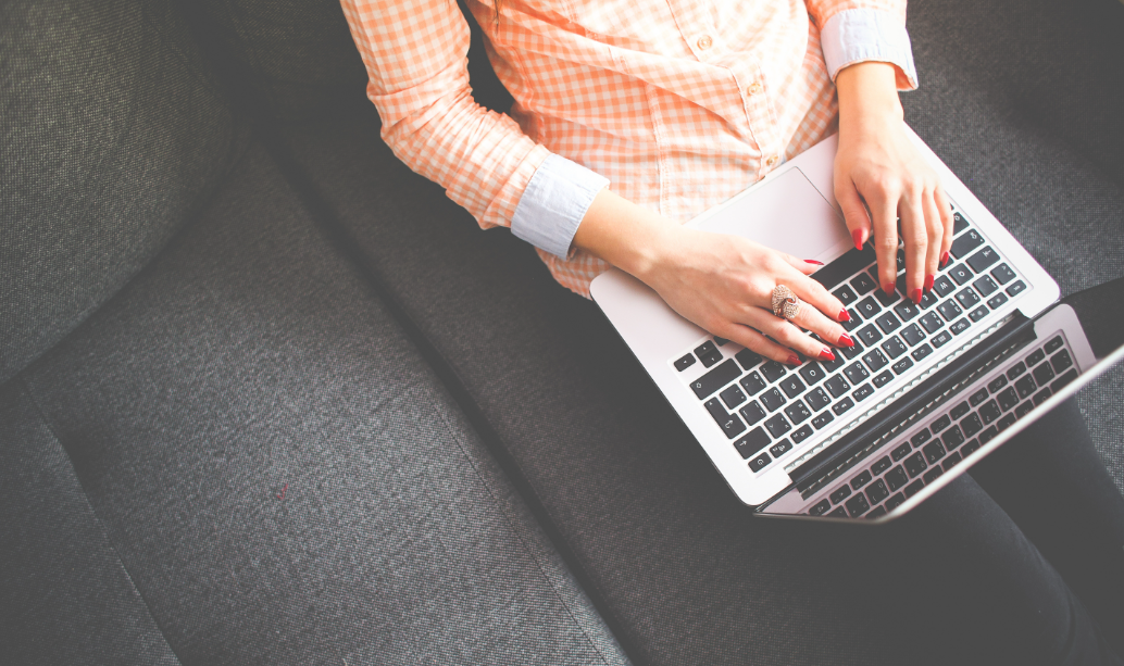 Lady sat at a laptop typing